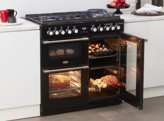 Black Belling CookCentre Deluxe cooker with food cooking inside which can be seen through the glass doors