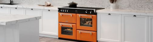 A bright orange colour boutique range cooker in a modern styled kitchen